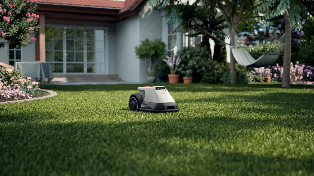 eufy Robot Lawn Mower E15 quietly mowing lush green grass in beautiful residential backyard garden