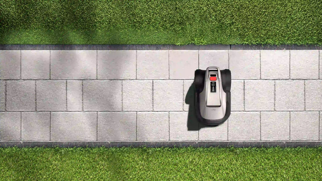 op view eufy E15 robot lawn mower on stone walkway