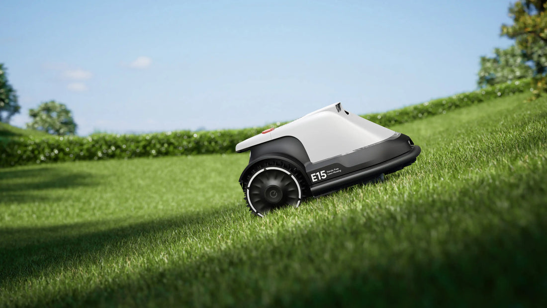 Side view of eufy Robot Lawn Mower E15 automatically trimming lush green grass in residential garden with hedges